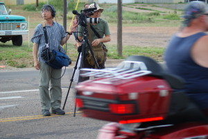 Camerman and soundman from Hong Kong dodge traffic on Route 66. (Photo by Kirsten Koza)