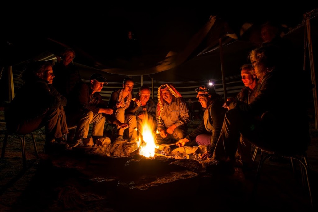 Our 2014 participants and local host, at the camp in Dana, roasting marshmallows around the fire. (Photo by Christopher Campbell, Writers' Expeditions)