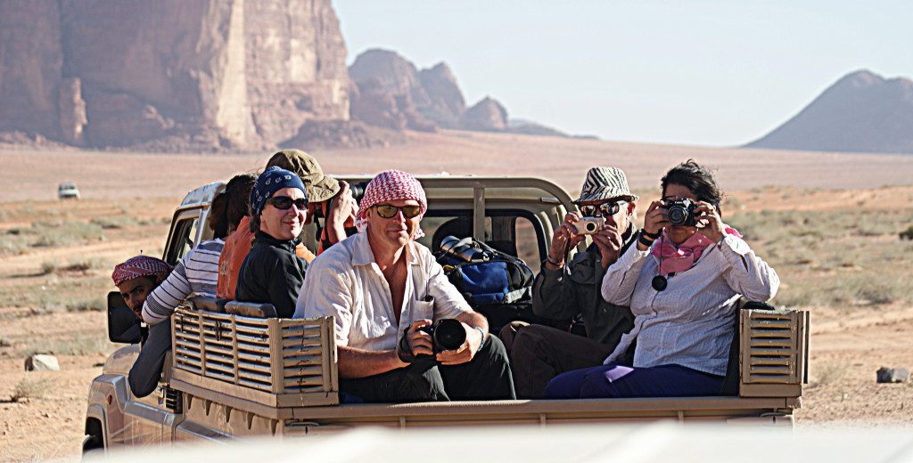 This is how we'll roll in Wadi Rum. That's Salem, our Bedouin host leaning out of his truck window. And that's Chris, your photography host, wearing his red and white keffiyeh in the back. (Photo taken by Kirsten Koza, your expedition host, standing in the back of another truck.)